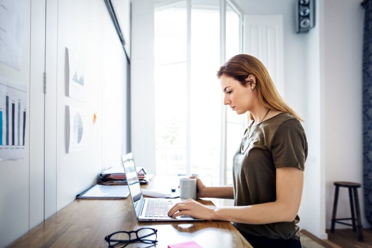 Business owner working on a laptop planning to move from Wix to WordPress