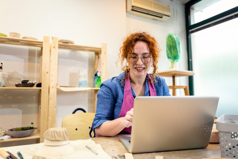 Small business owner working on a laptop: small business website cost