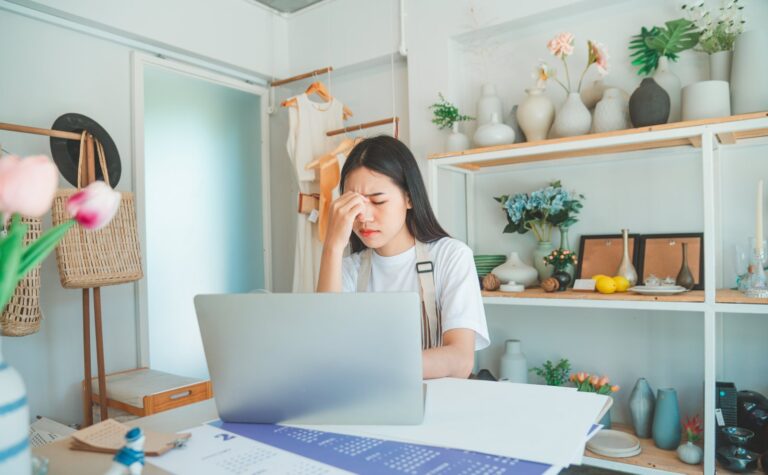 Business owner worried at a laptop after their web developer disappeared