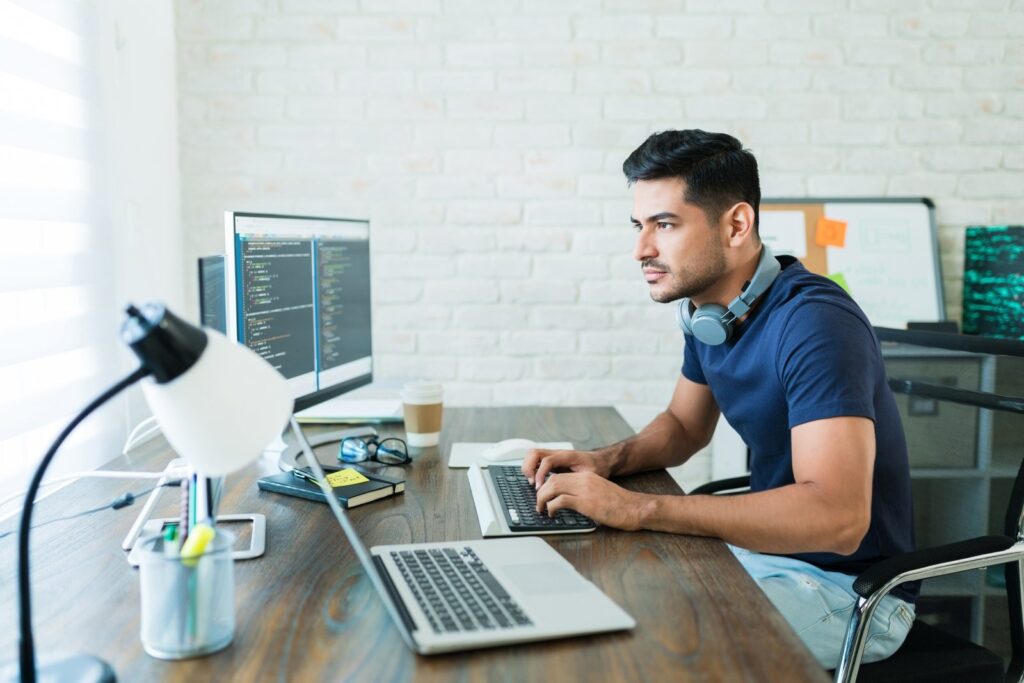 Developer updating a website on a laptop: WordPress maintenance plans