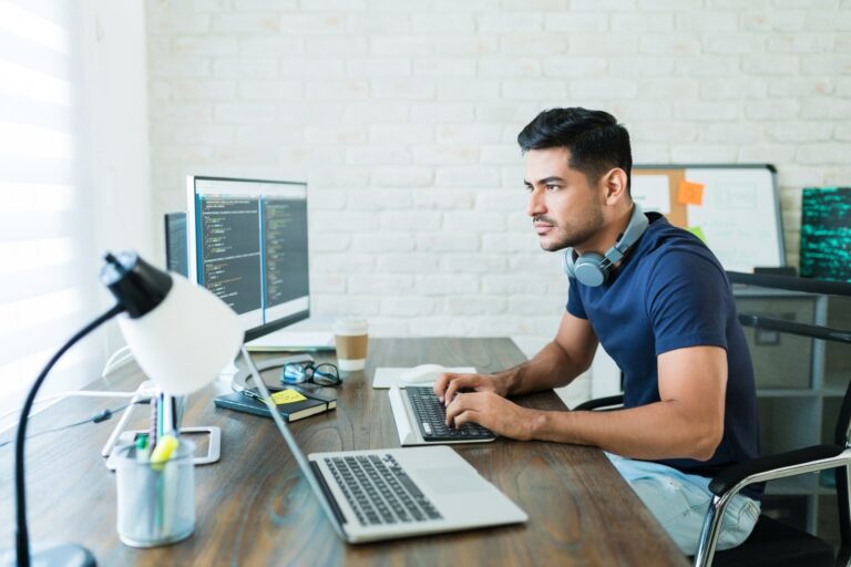 Developer updating a website on a laptop: WordPress maintenance plans